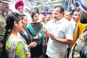 Union Railway Minister DV Sadananda Gowda interacts with women passengers at the Guwahati railway station on Tuesday