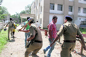 Police beat striking UPNL employees who tried to climb a water tank