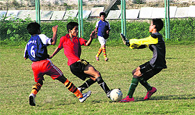 Players vie to take control of the ball in a match in the Dehradun District Inter School Under-14 Boys Football tournament at Pavilion Ground in Dehradun on Tuesday. Tribune photo: