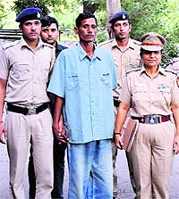 The accused, Sriniwas Yadav (centre), in police custody on Wednesday. 