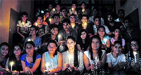Students organise a candlelight vigil in solidarity with the Indian defence forces' rescue operations in the flood-hit Jammu and Kashmir, at DAV College, Sector 10, Chandigarh, on Wednesday.