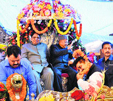 Chief Minister Virbhadra Singh and Minister for Social Justice and Empowerment Dhani Ram Shandil ride a traditional chariot during the Sair Fair at Arki in Solan on Wednesday.