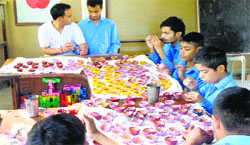 Students paint and prepare diyas (earthen lamps) ahead of the festive season at the Prayas School in Jalandhar. A Tribune Photograph