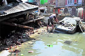 A man removes debris from his car