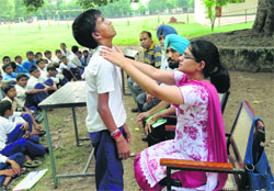 A doctor examines a government school student for goitre during a survey in Ludhiana district.