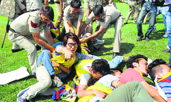Cops detain Tibetan youths protesting against the Chinese President outside the Chinese Embassy in New Delhi on Wednesday. AFP 