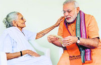 Prime Minister Narendra Modi seeks blessings from his mother Hiraba on his 64th birthday in Gandhinagar on Wednesday. Hiraba gave Rs 5,001 to Modi for J&K flood victims. PTI