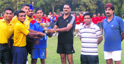Col H S Bainsla, Commandant, RIMC, presents the winning trophy of the Inter-section Football Tournament to the Pratap section players in Dehradun on Wednesday. A Tribune photograph