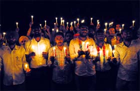 On a collision course: Members of the MGNREGA Contract Employees Union hold a candlelight march in protest against the Punjab Government in Bathinda on Thursday.