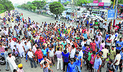 Residents of Phali Mandal village block the national highway at Satwari Chowk in Jammu on Thursday