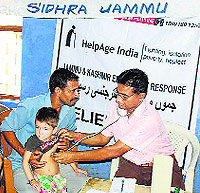 A doctor examines a patient at a medical camp in Jammu