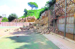 A section of the pitch covered by rubble after rain caused a landslide at the hillock adjoining the field. 