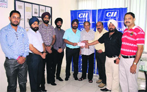 Members of the Amritsar Computer Traders Association hand over a cheque for Rs 50,000 to CII Amritsar for Jammu and Kashmir flood victims in Amritsar on Friday.