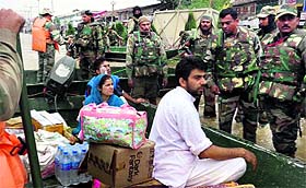 Personnel of the Bathinda Military Station distribute the relief material among the flood-affected people in Kashmir on Friday.