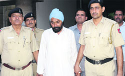 The accused in police costody at the Sector 9 Police Headquarters in Chandigarh on Friday. Tribune Photo: S Chandan