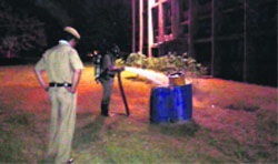 Fire officials try to control the leakage in a chlorine cylinder at Panjab University. Tribune Photo: Amit Sharma