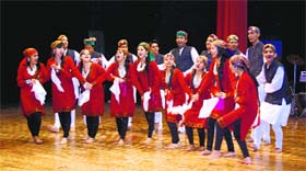 Girl students perform a dance during the freshers party at the DRPGMC auditorium in Kangra.