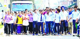 Students of KC College, Pandoga, take to the streets at Haroli in Una on Friday.