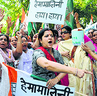 Congress workers protest BJP MP Hema Malini's remark on widows outside the BJP headquarters in New Delhi on Friday