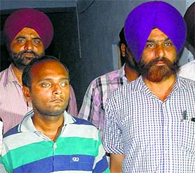 Accused Kamal Verma of Muzaffarnagar (left) in police custody in Amritsar on Friday.