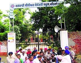 After locking the main gate of Government Senior Secondary School, villagers stage a dharna in Mehlan village, 10 km from Sangrur, on Friday. 