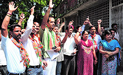 BJYM workers protest outside the District Magistrates office in Dehrdaun on Friday