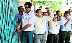 Teachers lock the Education Directorate office in Dehradun on Friday