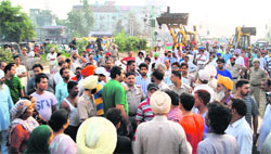 Shopkeepers protest as the Municipal Corporation initiated a drive to remove shacks on the GT road in Amritsar on Saturday. PHOTO: RK Soni