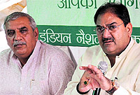 INLD leaders Abhay Singh Chautala (right) and Ashok Arora at a press conference in Chandigarh on Saturday