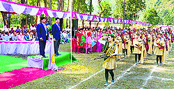 DGP Sanjay Kumar takes the salute from the parade during the annual sports day of Kullu Valley School in Kullu on Saturday