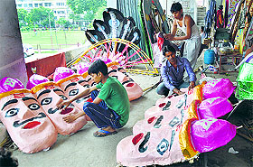 Artists prepare an effigy of Ravana at Daresi Ground in Ludhiana.