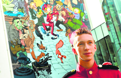 A young man dressed as Belgium comics hero Spirou poses during the unveiliing of a mural celebrating Spirou, during the “Fete de la BD” (Illustrated Comics Festival) in Brussels.
