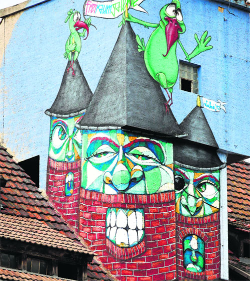 One of several graffiti covering abandoned houses is seen on a house wall in Halle, Germany.
