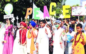 Walk for harmony: Students from various schools take part in a walk to observe the International Day of Peace at Sukhna Lake in Chandigarh on Sunday.