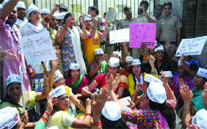 AAP supporters stage a protest outside the residence of former party leader Vinod Kumar Binny against his comment on their leader Alka Lamba on a social networking site, in East Delhi on Sunday.