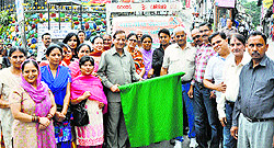 BJP leader Kishan Kapoor flags off a relief material truck for flood victims of Jammu and Kashmir in Dharamsala on Sunday