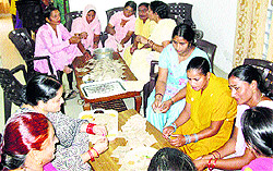 Members of the Swan Women Federation pack kitchen garden seed kits in Una on Sunday