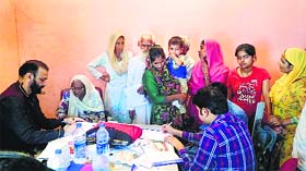 Doctors examine patients at a medical camp at RS Pura in Jammu on Sunday.
