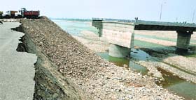 Repair work on the fourth bridge on the Tawi, a part of which was washed away in the floods, is going on at a snails pace.