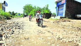 A damaged road poses threat to commuters in Jammu.