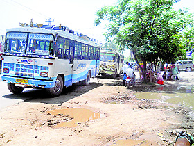 Private buses pick up passengers outside the newly constructed bus stand in Bassi Pathana.
