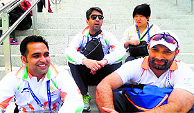 Shooters Abhinav Bindra, Omkar Singh, Harpreet Singh take a break after a hectic day.