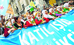 Women carry a banner reading Murderer Islamic State during a protest against Islamic State militant attacks on Syrian Kurds, in Istanbul on Sunday
