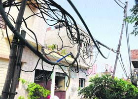 Residents of Sandhu Colony have installed bamboo sticks on the road to raise the dangling wires in the area in Amritsar