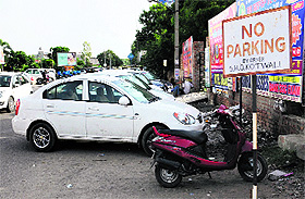Vehicles parked in a No Parking Zone despite a signboard in front of the Mittal Mall in Bathinda on Monday.