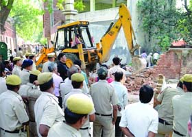 MCD workers demolish an unauthorized construction on Tibia College campus, Karol Bagh in New Delhi on Monday