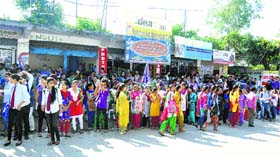 Students of the NSCB Government College wait for the gates to open in Hamirpur on Monday.