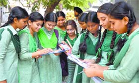 Schoolchildren discuss the question paper after appearing for an examination in Ludhiana on Monday.