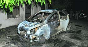 A car after it was set ablaze by unidentified persons.