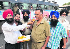Members of the CTU Conductors Union celebrate at the ISBT in Sector 17, Chandigarh, on Tuesday.